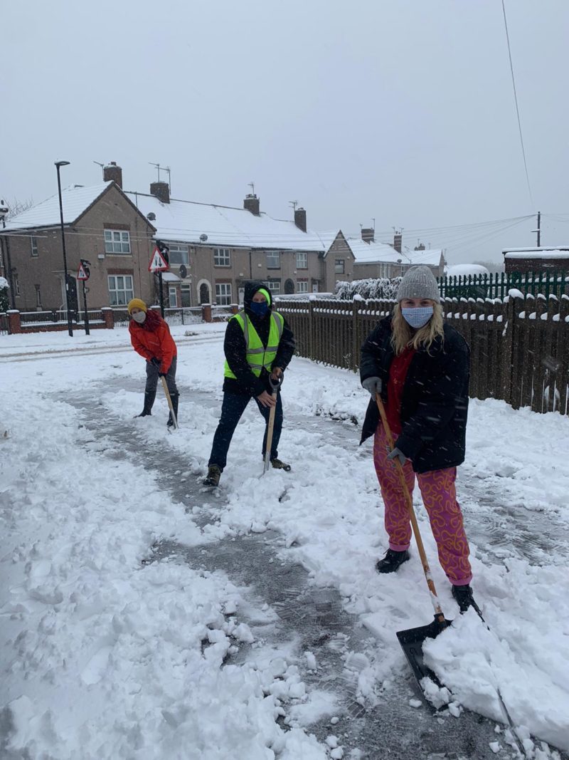 Councillors Ben Miskell, Jack Scott and Sophie Wilson shovelling the snow outside Arbourthorne Care Home