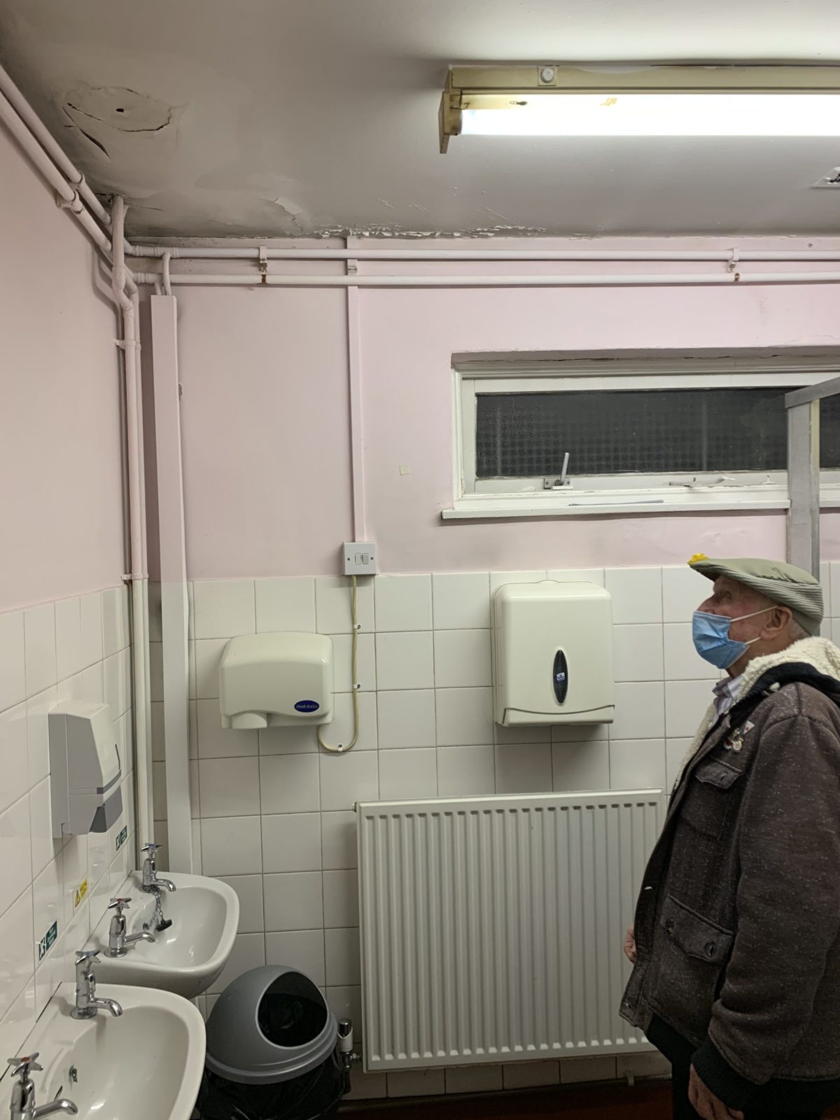 Local resident and Arbourthorne TARA member Derek Smith looking at water damage to the inside of the Community cENTRE