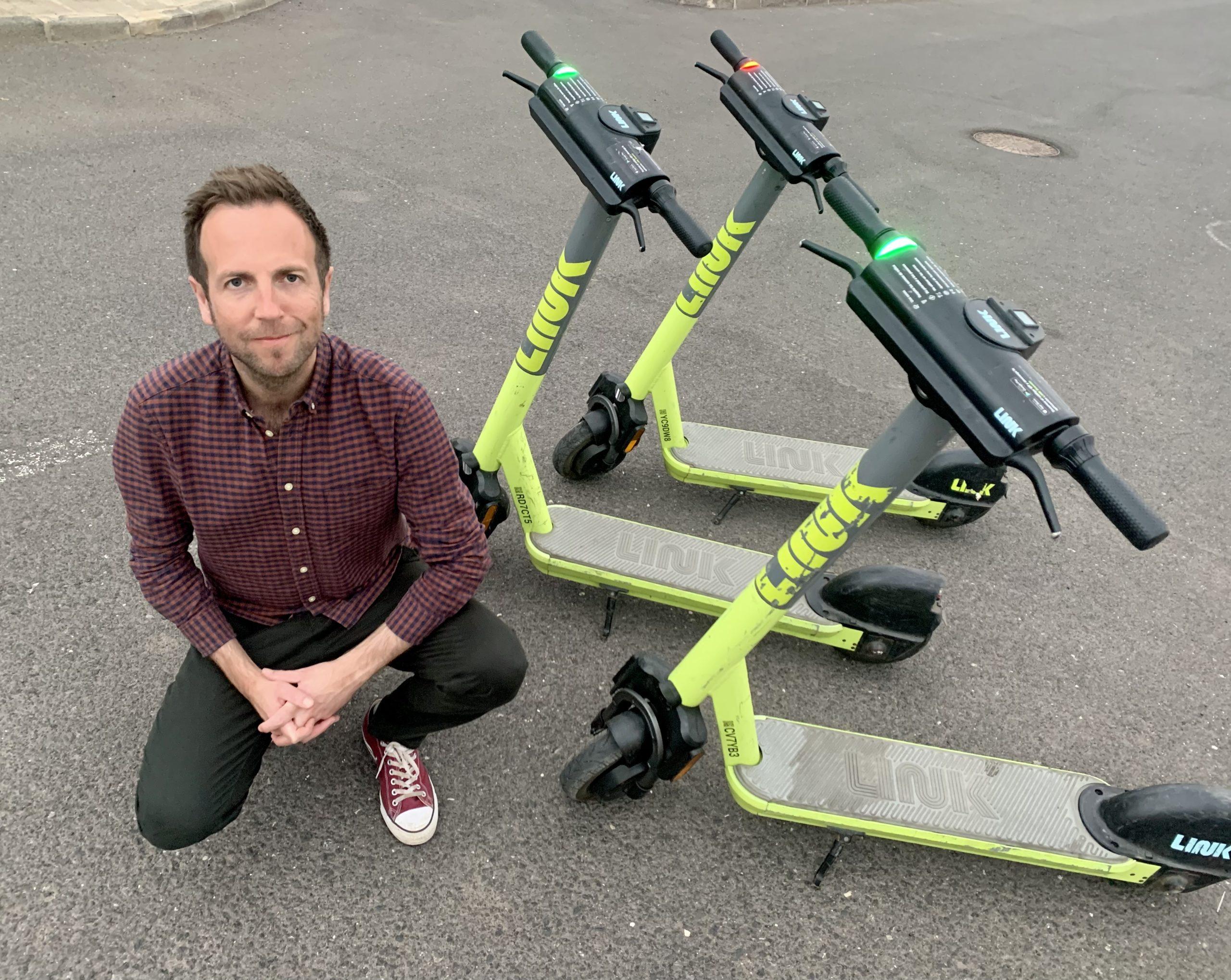 Cllr Ben Miskell with legal rental scooters which are available in some English cities